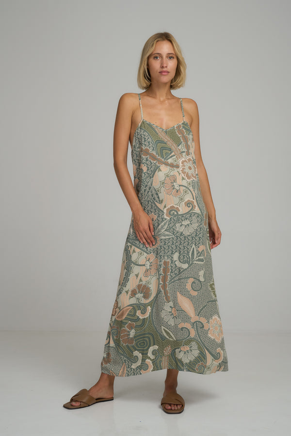 A model wearing a green batik print maxi dress