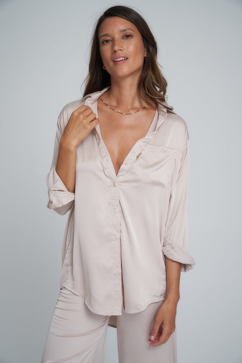 A Woman Wearing the Roshi Silky Top by LILYA in Oyster