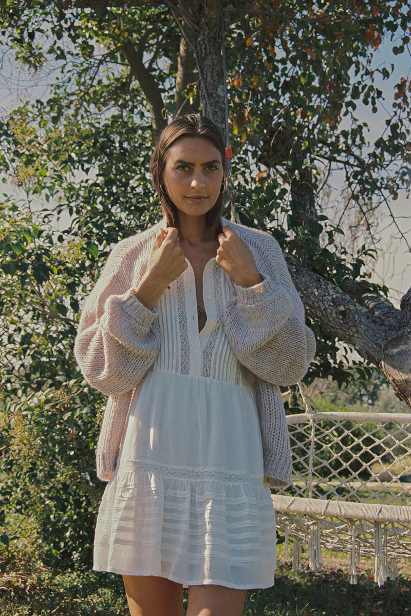 A model wearing a pink longline cardigan