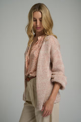 A model wearing a pink cardigan for layering