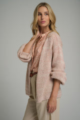 A woman wearing a pink casual cardigan