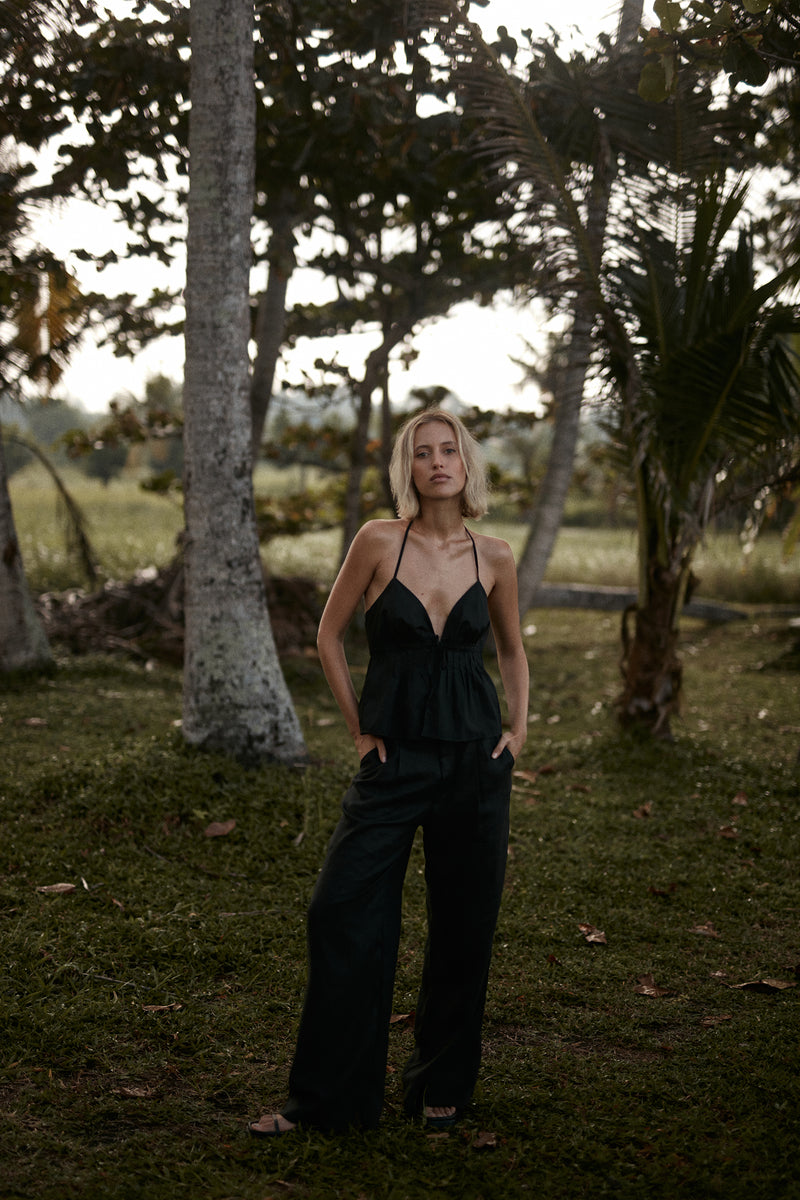 A model wearing black linen pants in Australia