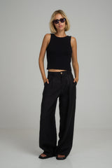 A model wearing classic black linen pants