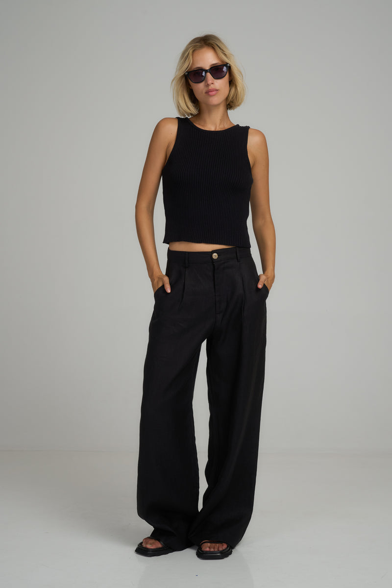 A model wearing classic black linen pants