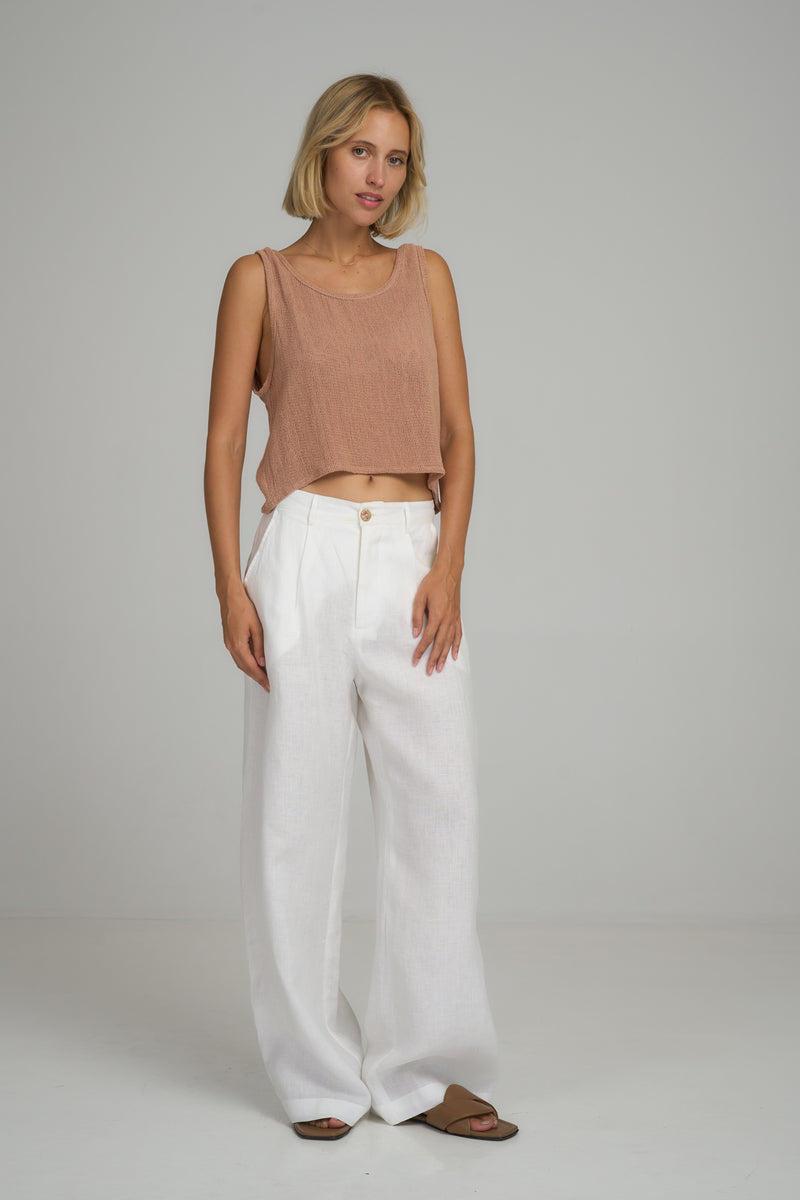 A model wearing white linen dress pants in Australia