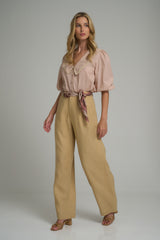 A model wearing mustard coloured linen pants