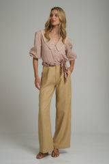 A model wearing high rise linen work pants