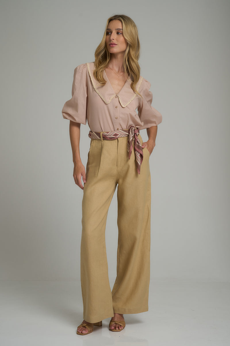 A model wearing high rise linen work pants