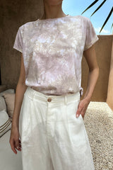 A model wears a light pink tie dye t-shirt