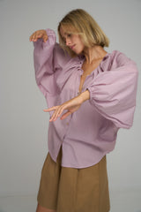 A woman wearing a lilac boho cotton blouse for Summer