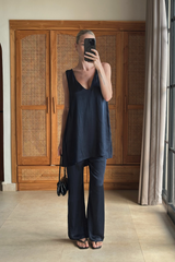 Navy satin mini dress styled with straight leg pants 