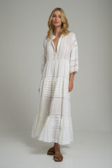 A model wearing a white cotton maxi dress
