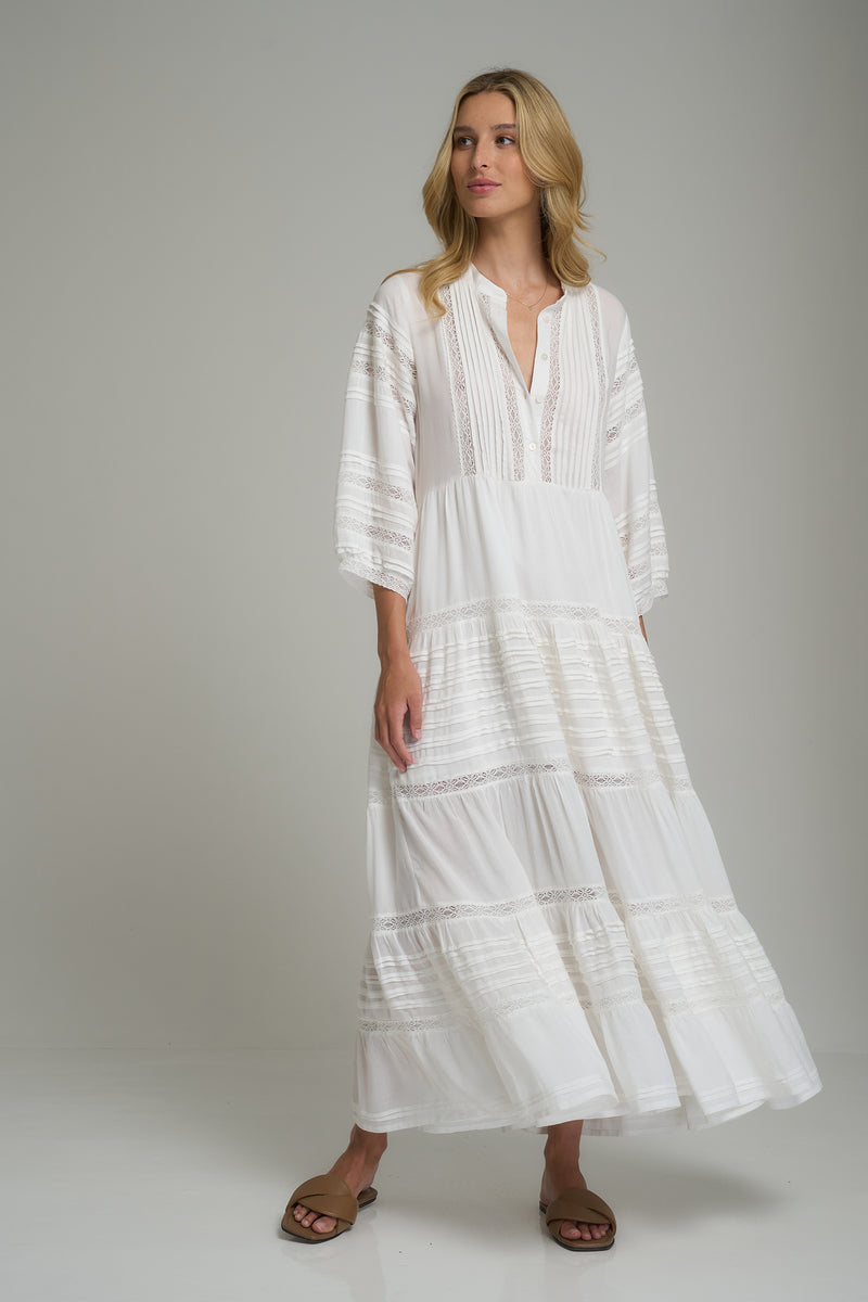 A woman wearing a white rayon lace maxi dress