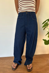 Girl wears baggy fit workwear style dark wash jeans