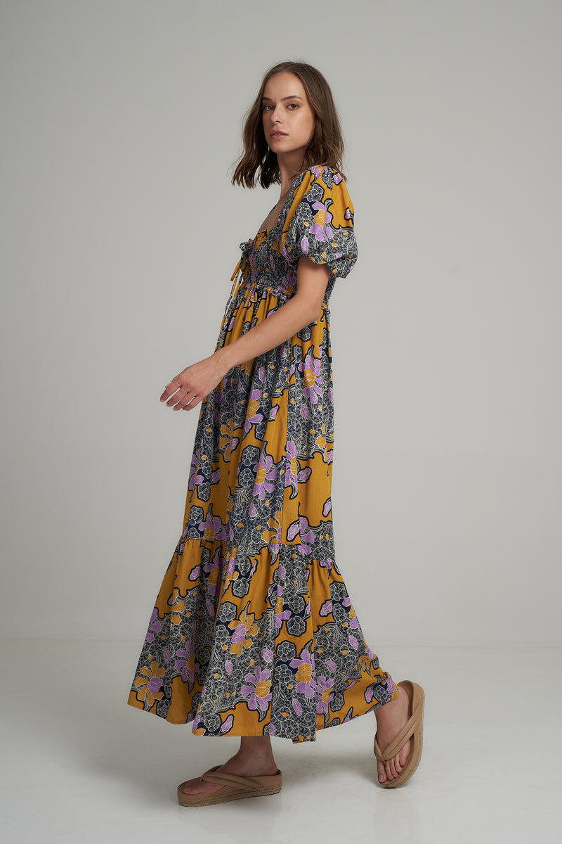 A Model Wearing a Batik Floral Maxi Dress by LILYA