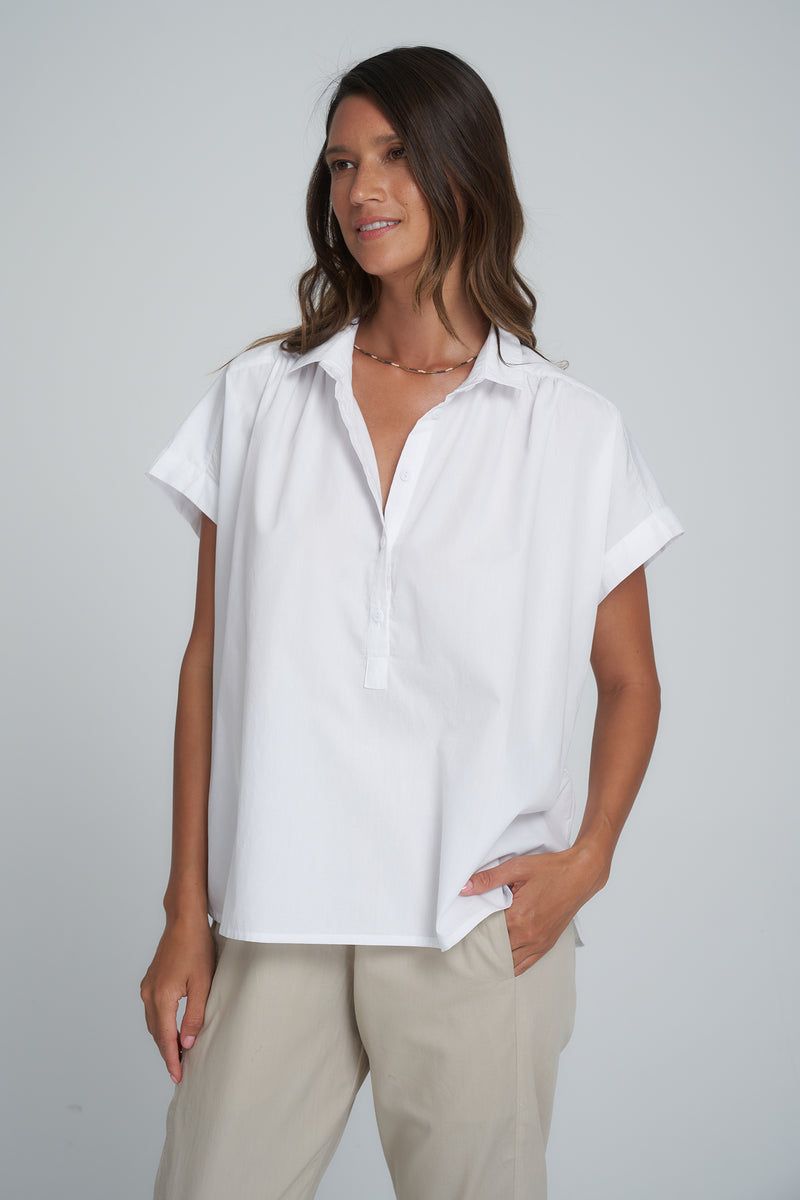 A Woman Wearing a White Cotton Blouse with Short Sleeves