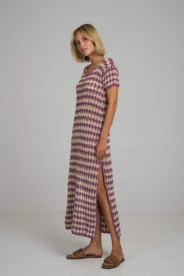 A model wearing a vintage inspired crochet maxi dress