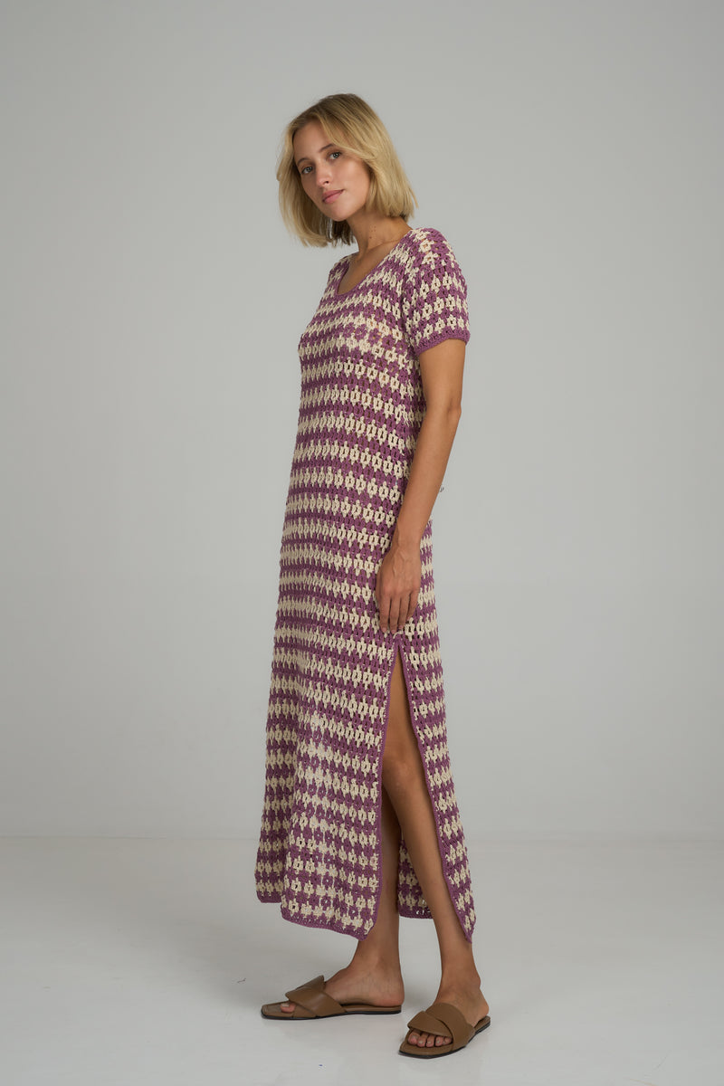 A model wearing a vintage inspired crochet maxi dress