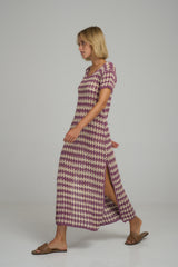 A woman wearing a purple and ivory crochet casual maxi dress