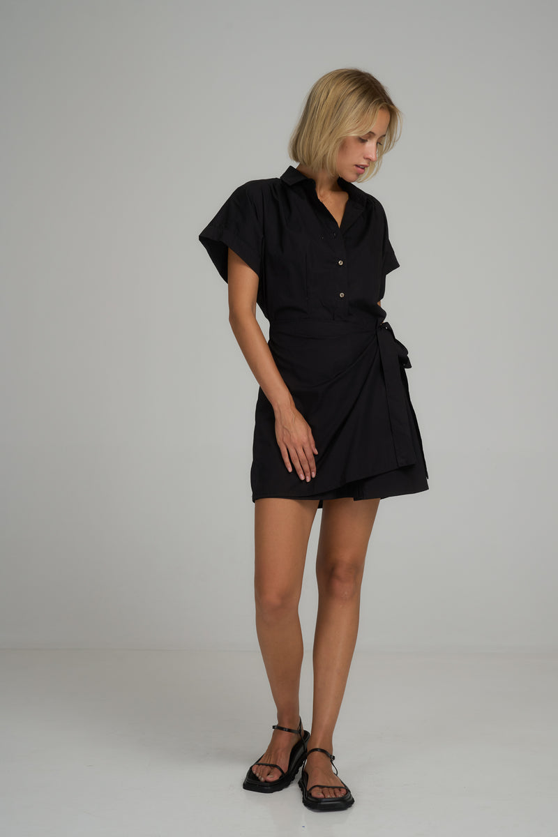 A model wearing a black cotton mini dress by LILYA