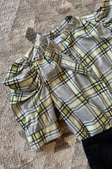 Flatlay image of a cotton check blouse