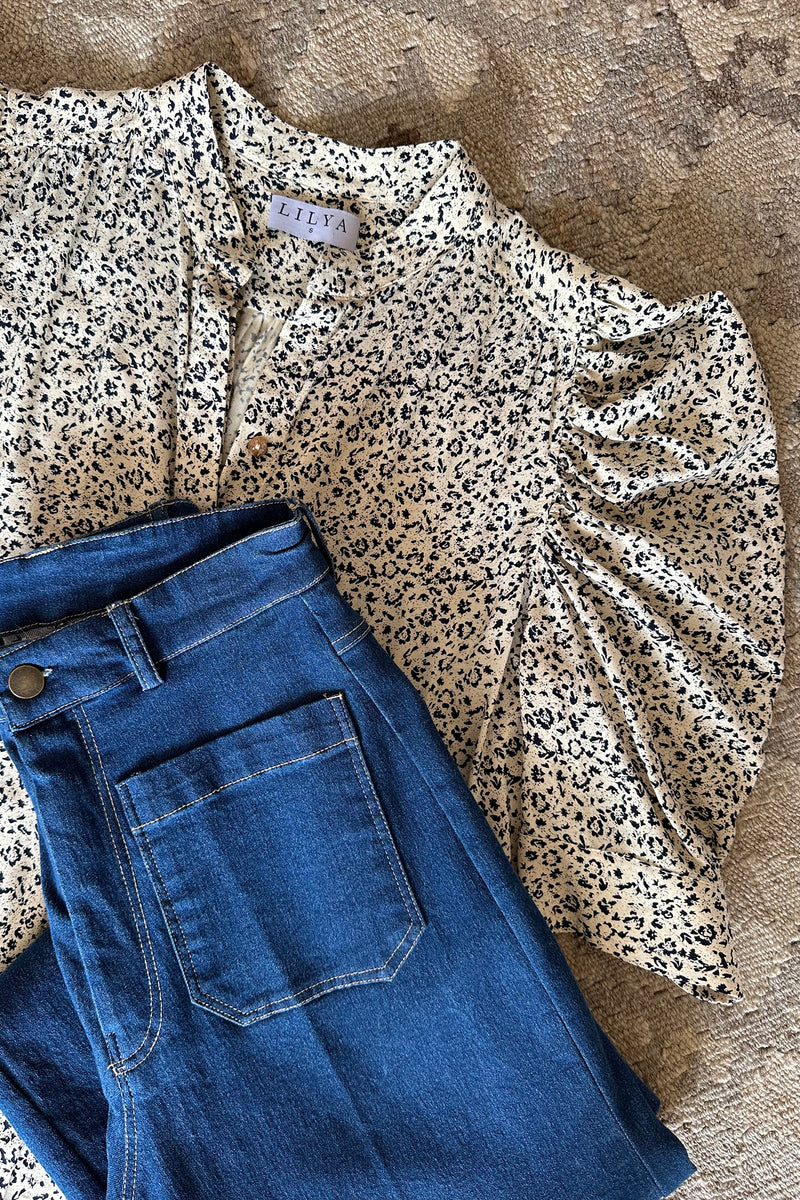 An image of a floral blouse with puff sleeves