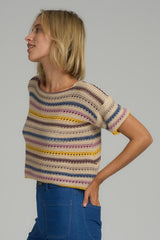 A woman wearing a cropped striped knit top