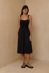 Black cotton midi dress with feminine silhouette and tie straps 