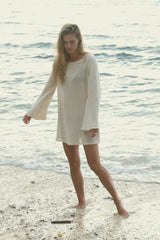 Woman by the sea in the cream coloured mesh dress by LILYA.