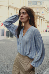 Side view of a blue striped long sleeve top by Lilya