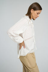 Model wearing LILYA Azalea Lace Top in white cotton with lace trims styled with Utility Pant in Sand