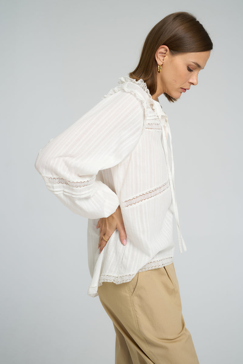 Model wearing LILYA Azalea Lace Top in white cotton with lace trims styled with Utility Pant in Sand