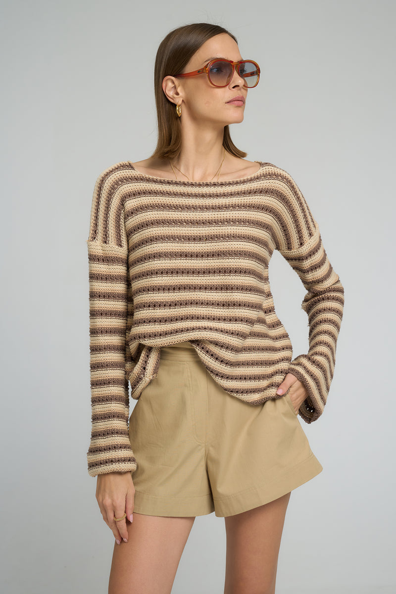 Model wearing LILYA Collectiva Stripe Knit Top in earth tone stripes paired with Anise Shorts in Sand