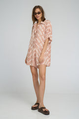 Model wearing playsuit with button-down front and soft rayon texture