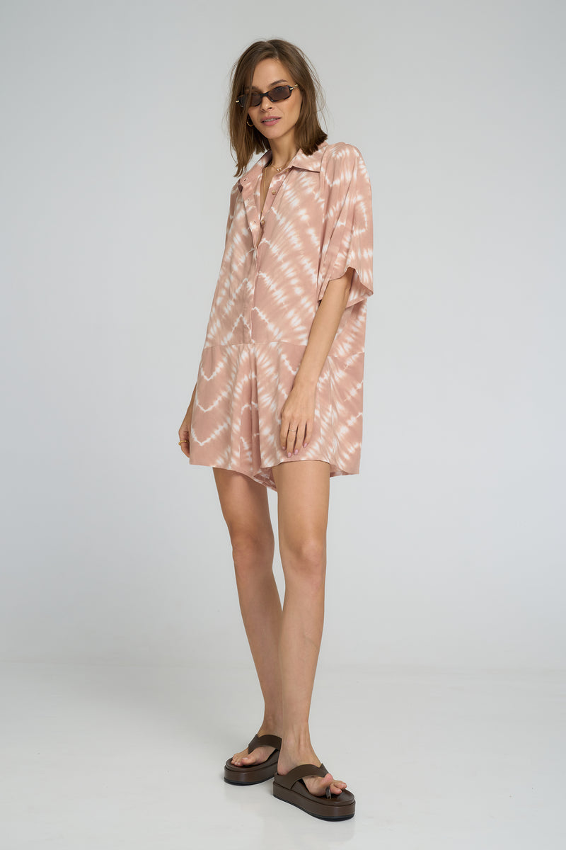 Model wearing playsuit with button-down front and soft rayon texture
