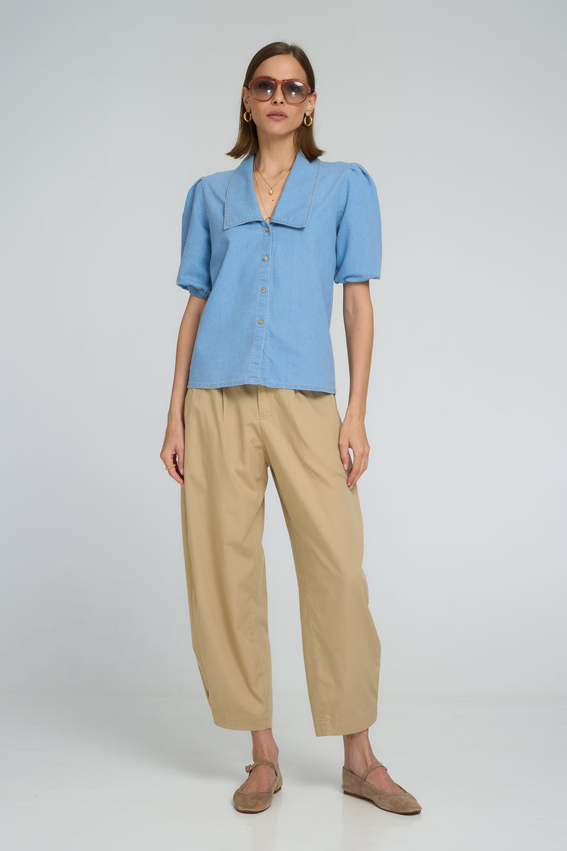 Light blue chambray blouse with oversized collar, balloon sleeves, and front resin buttons