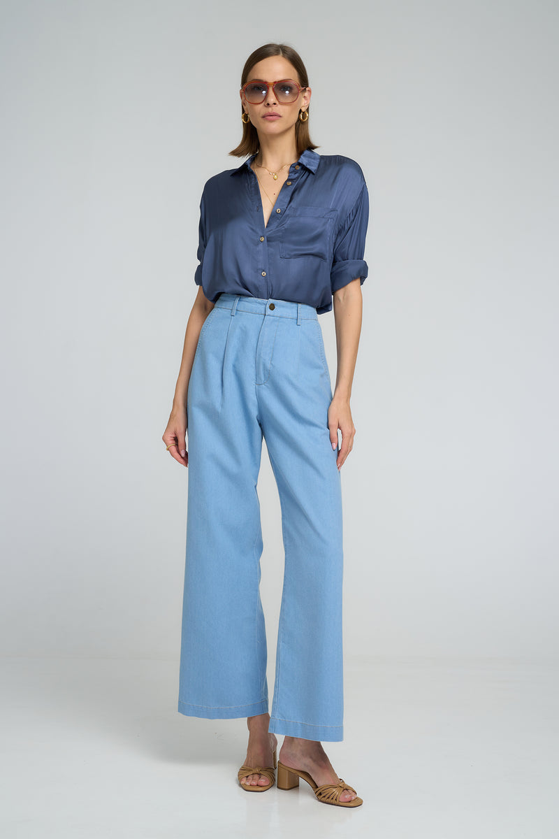 High-waisted cotton chambray pants with loose leg fit styled with a navy shirt