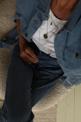 A model wearing a denim jacket and jeans