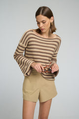 Woman styling LILYA Anise cotton shorts with a striped knit