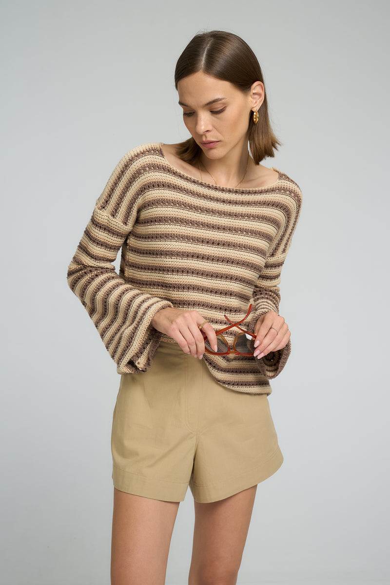 Woman styling LILYA Anise cotton shorts with a striped knit