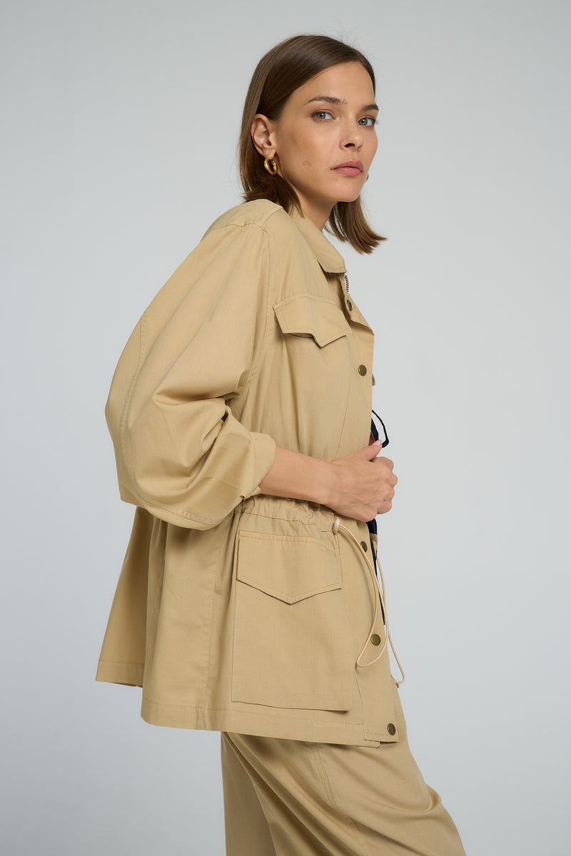 Weekend-ready cotton jacket styled over relaxed neutral trousers, LILYA outfit.