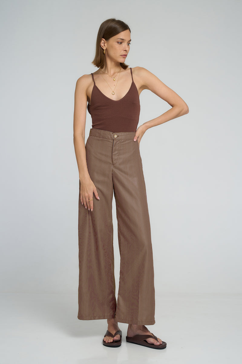 Model wearing LILYA Rio Pant in cocoa stripe cotton