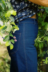 Side view of the Echinacea Denim Jeans with a floral embroidery and contrast stitching detail.