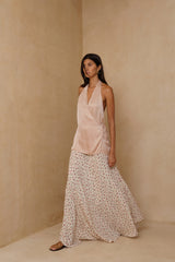 Satin halter top in Antique Rose styled with flowing floral maxi skirt
