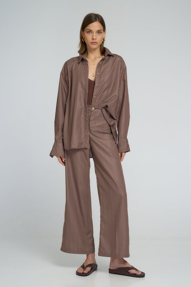 Model wearing LILYA Rio Pant and Hasting Shirt in cocoa stripe cotton