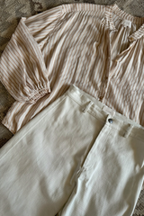 Flat lay photo of cream-coloured wide-leg pants