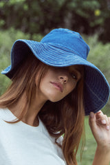 A Woman Wearing a Denim Blue Hat by LILYA