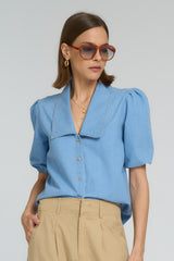 A model wearing a light blue fashion cotton top