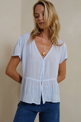 Button front powder blue blouse relaxed peplum hem silhouette