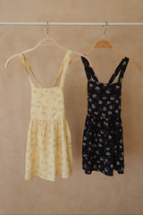 Yellow and Navy Yarrow floral girls pinafore dresses from the JKB x LILYA collaboration. 